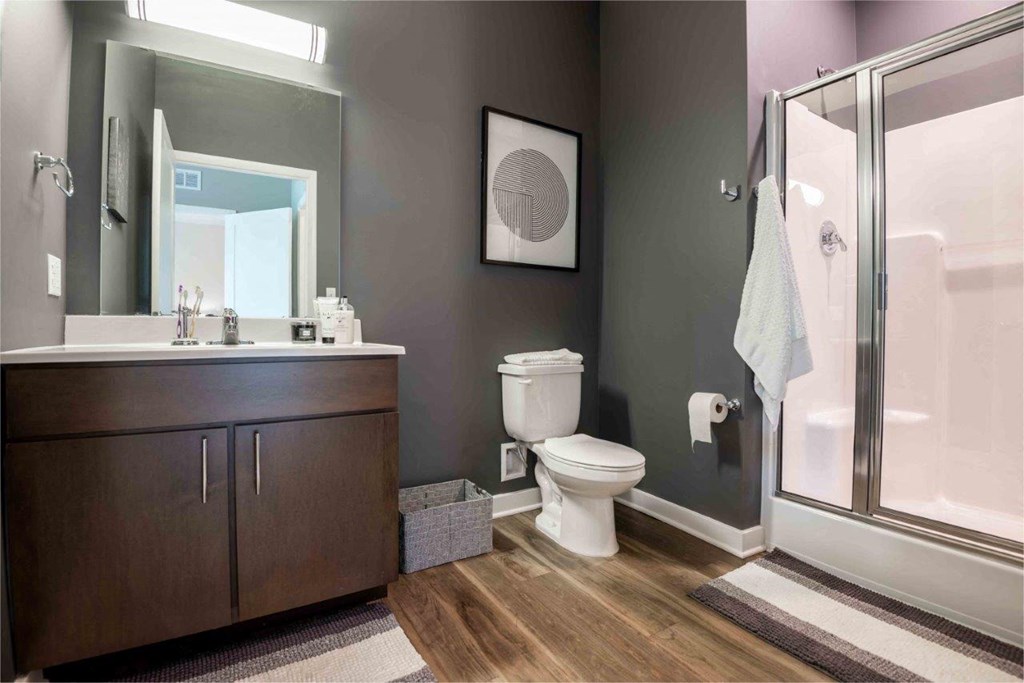 a bathroom with a toilet and a sink and a shower