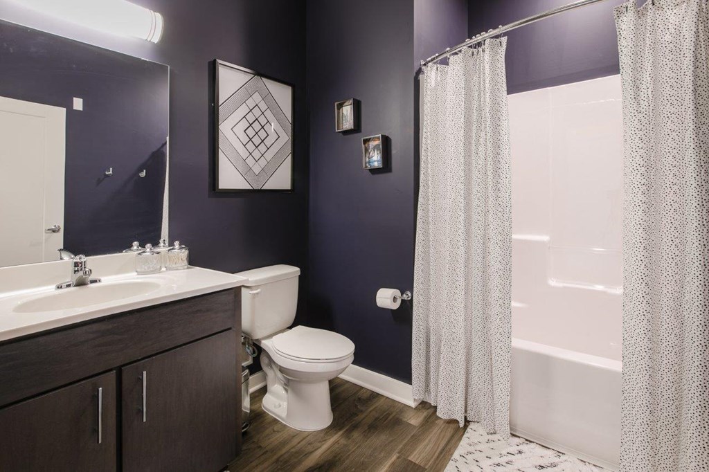 a bathroom with a toilet sink and shower