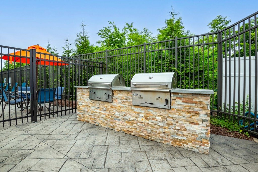 the clubhouse has a bar with two grills and a picnic table