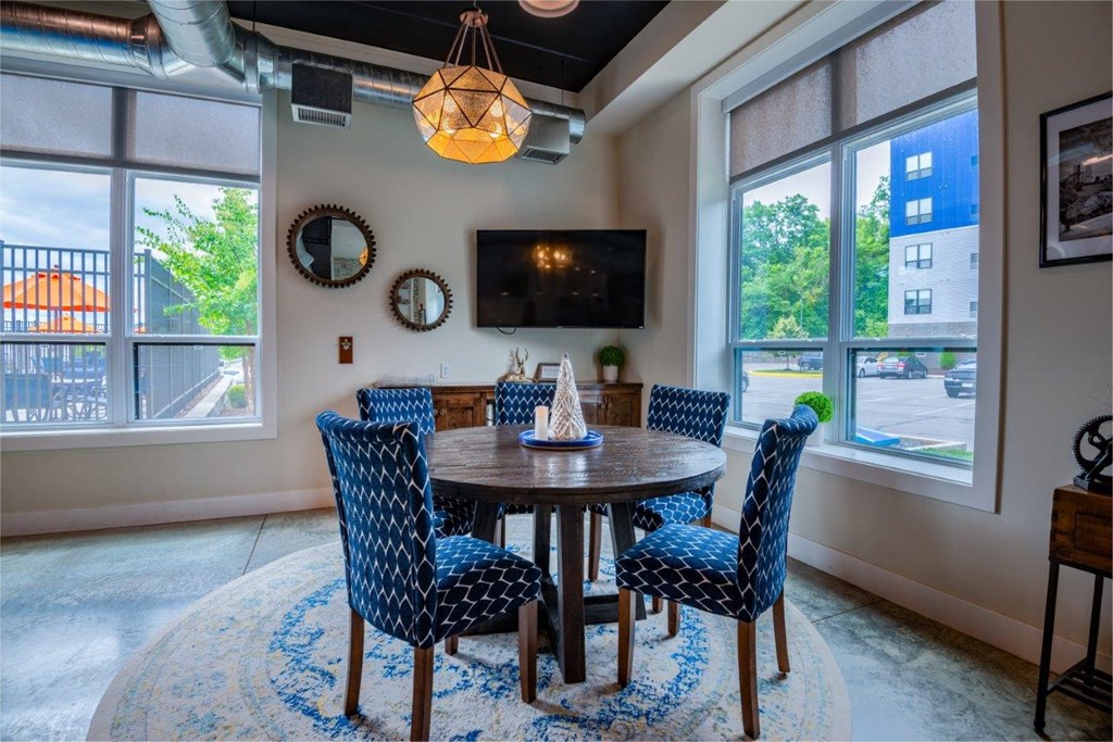 a dining room with blue chairs and a wooden table