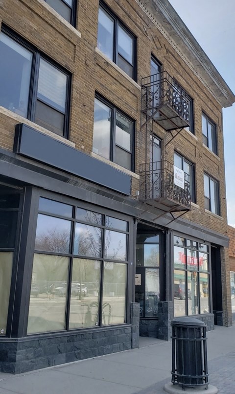 a brick building with windows and a balcony