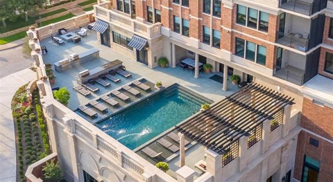 an aerial view of an apartment building with a swimming pool
