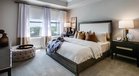 a bedroom with a large bed and a large window