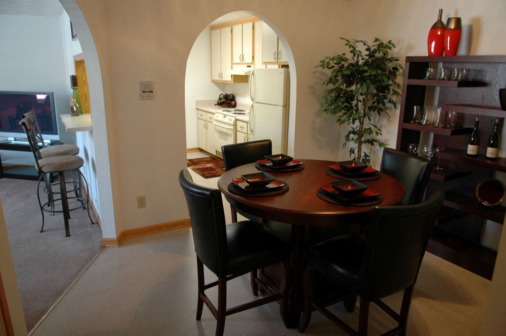 a dining room and kitchen with a table and chairs
