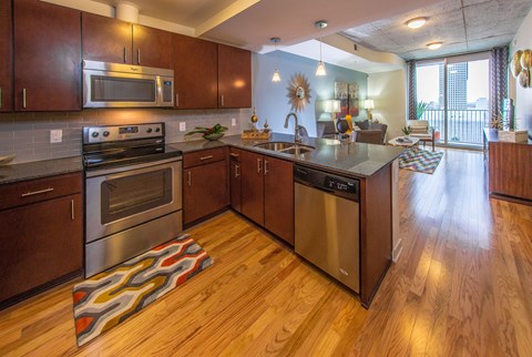 A modern kitchen with wooden cabinets and stainless steel appliances.