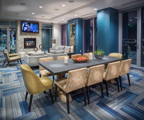 A modern dining room with a large table and chairs.