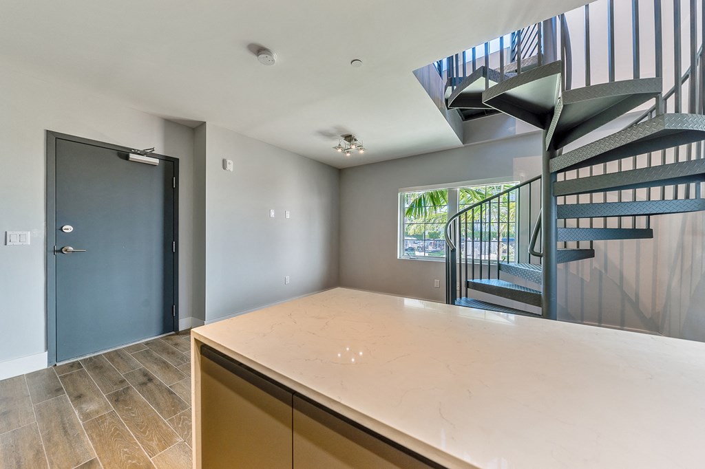 a kitchen with a counter top and a spiral staircase