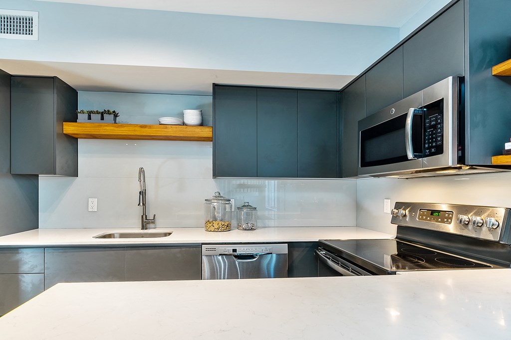 a kitchen with stainless steel appliances and a counter top