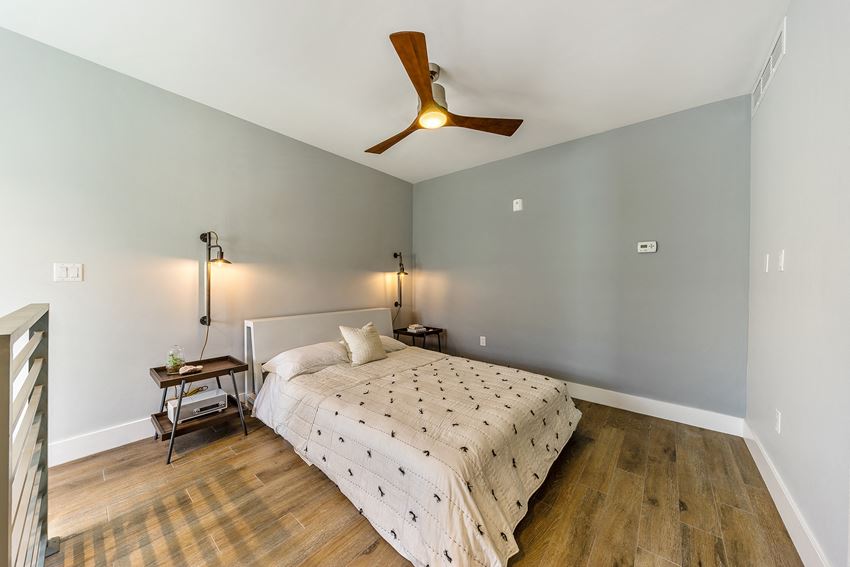 a bedroom with a bed and a ceiling fan
