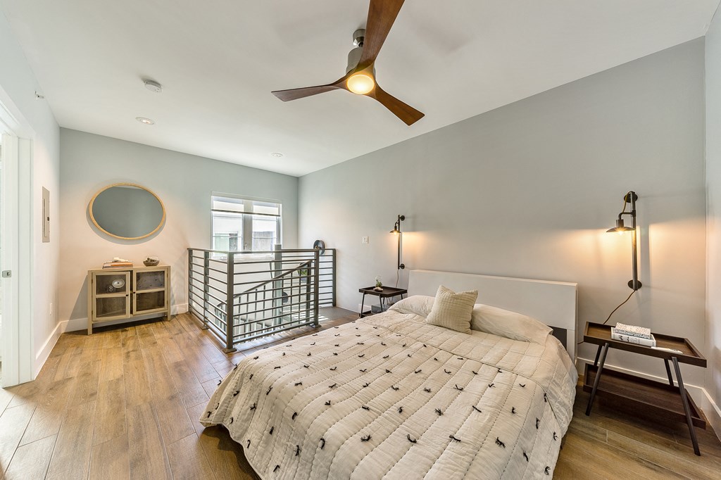 a bedroom with a bed and a ceiling fan