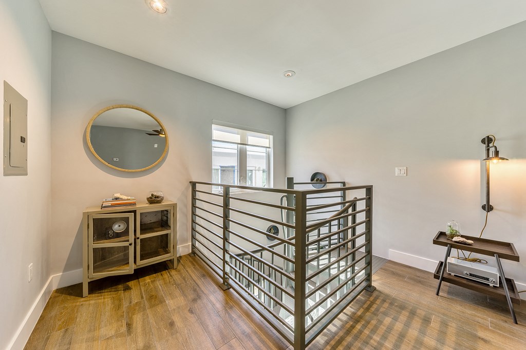a living room with a staircase and a window