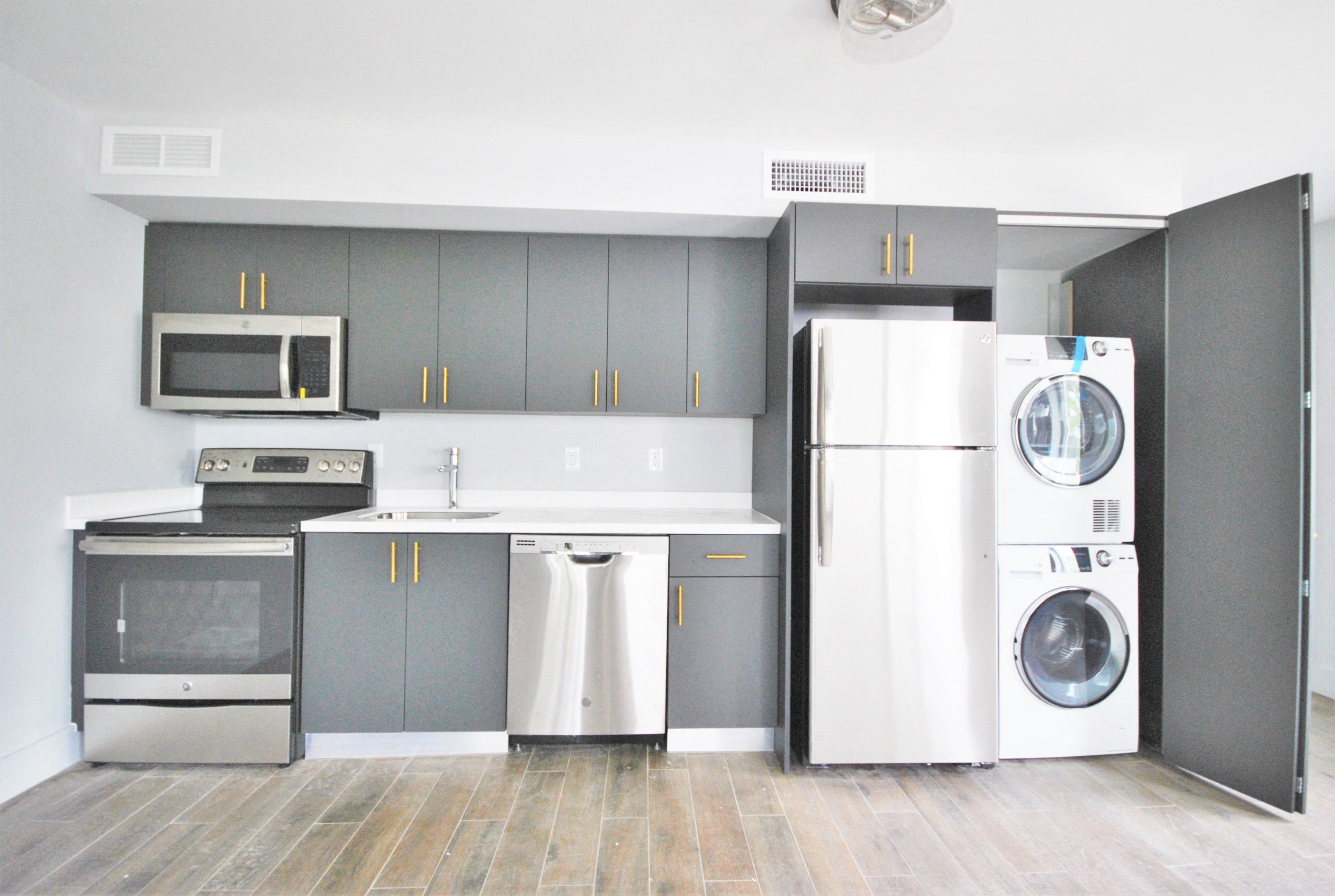 a laundry room with a washer and dryer and a white refrigerator