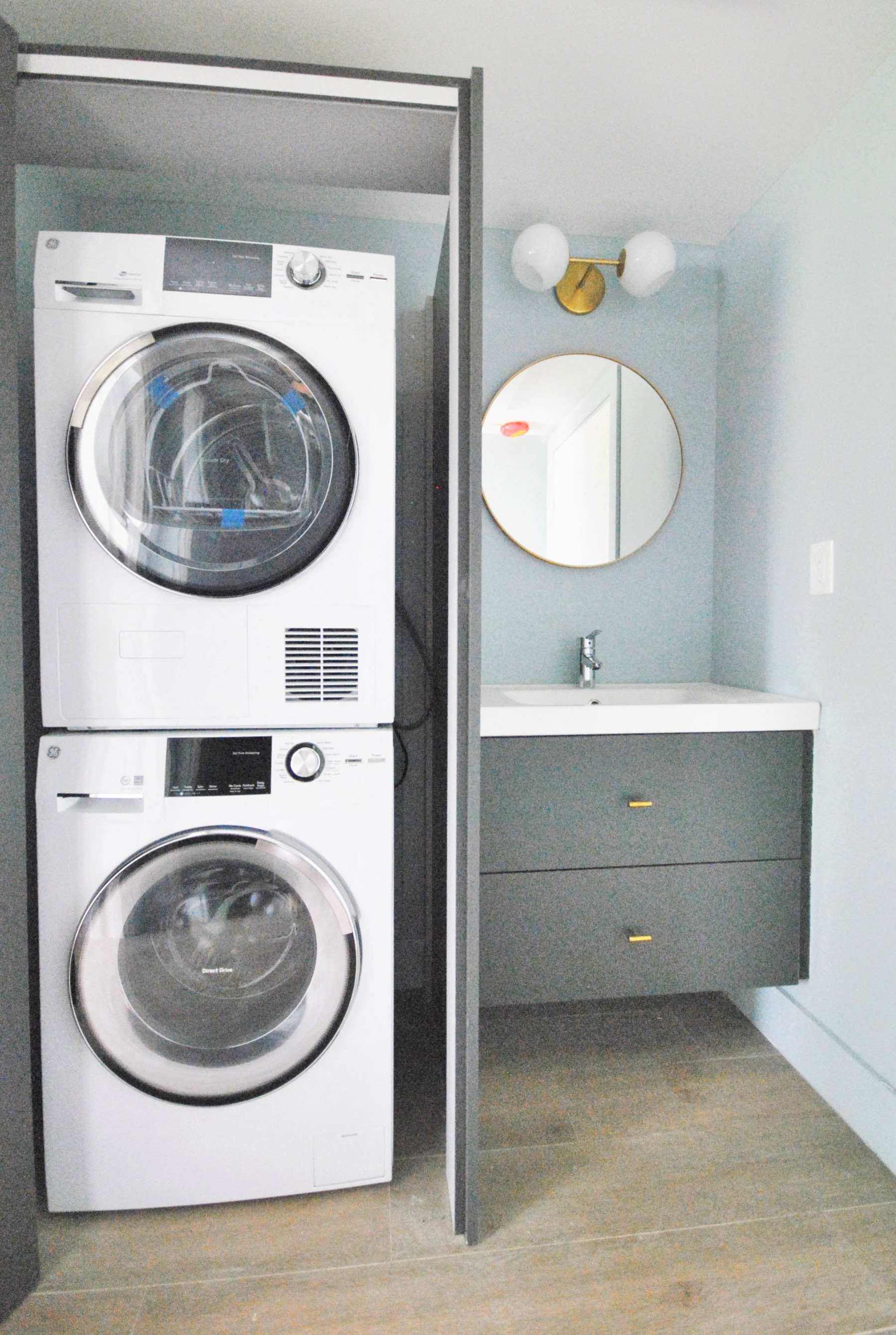 a small laundry room with a washing machine and a sink