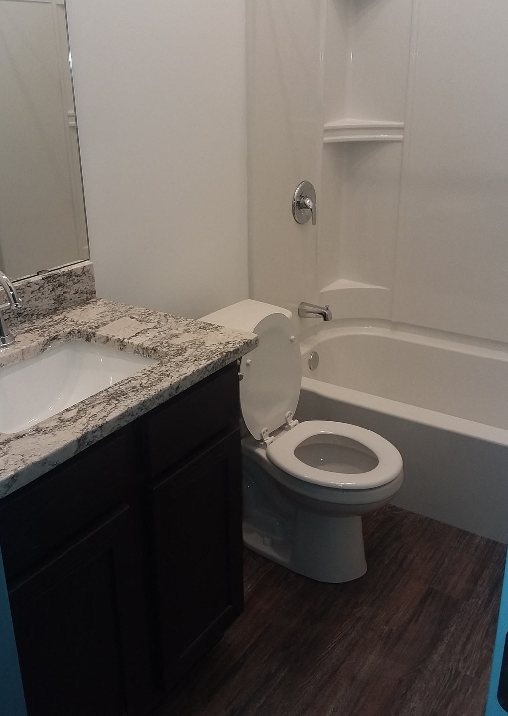 a bathroom with a toilet and a sink and a bath tub