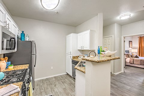 A kitchen with a stove top oven and a refrigerator.