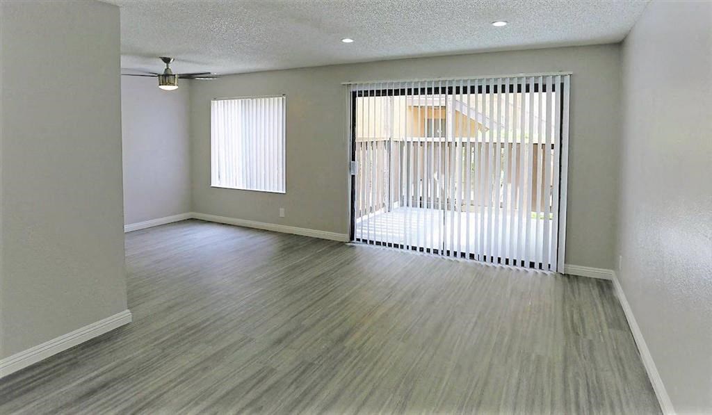 an empty living room with a sliding glass door