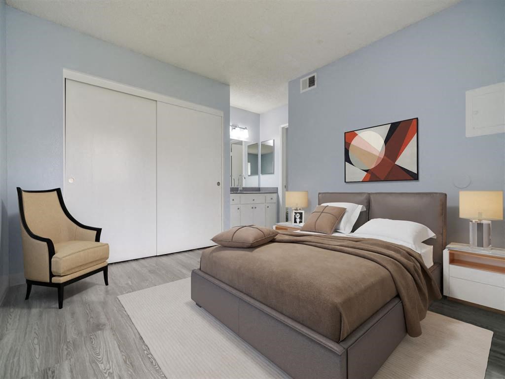 a bedroom with a bed and a chair and a closet