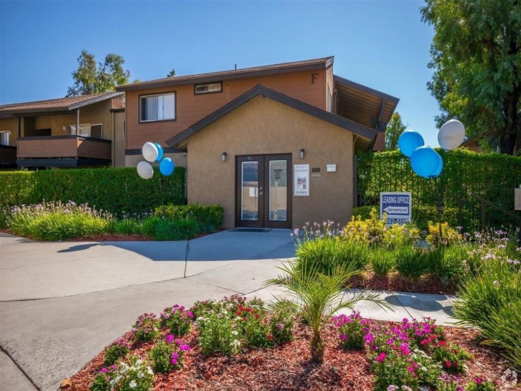 the front entrance of a house with balloons in front of it