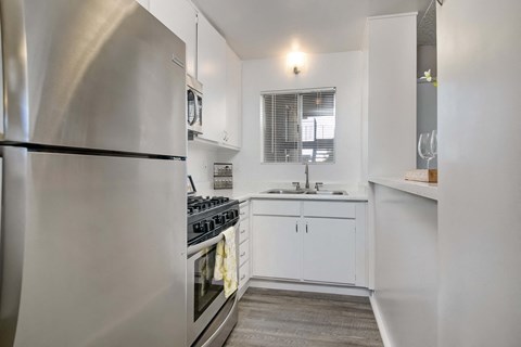 a kitchen with stainless steel appliances and white cabinets