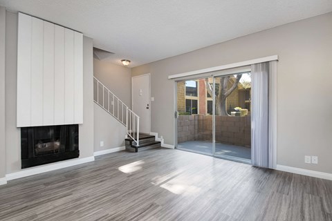 the living room has a fireplace and sliding glass doors to the patio