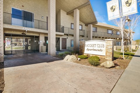 an apartment building with a sign for the acacia club apartments