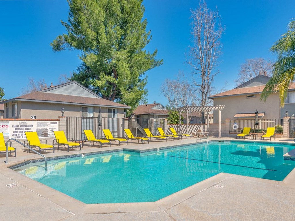 Temecula apartments with a swimming pool with yellow chairs