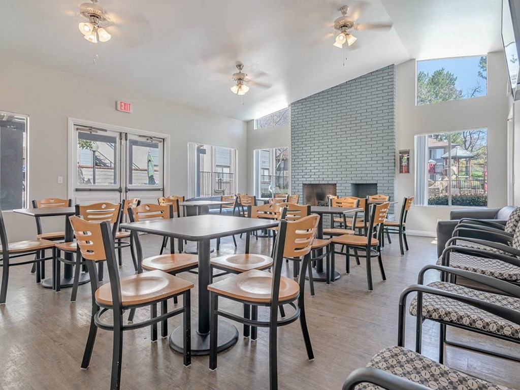 public dining area with tables and chairs and a fireplace