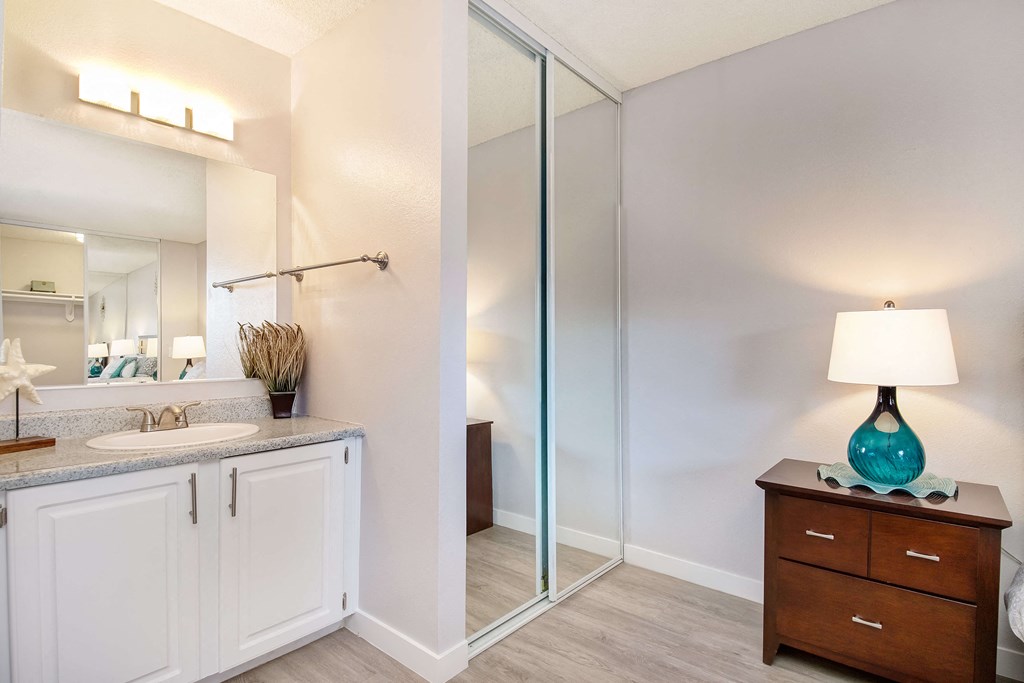 a bathroom with a shower and a sink and a mirror