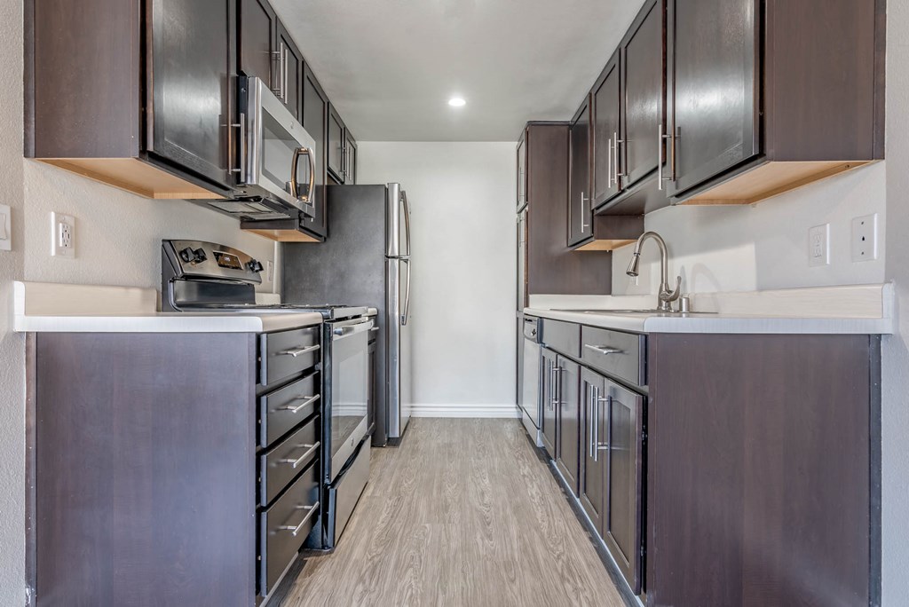 a kitchen with stainless steel appliances and wooden cabinets