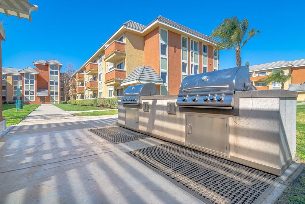 a barbecue grill in front of an apartment building