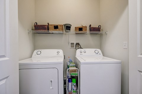 an empty laundry room with two washes and a dryer