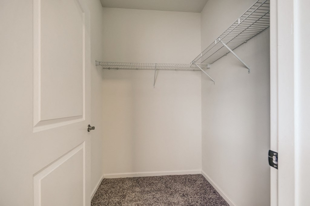 an empty closet in a home with a white door
