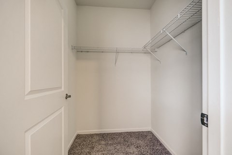 an empty closet in a home with a white door