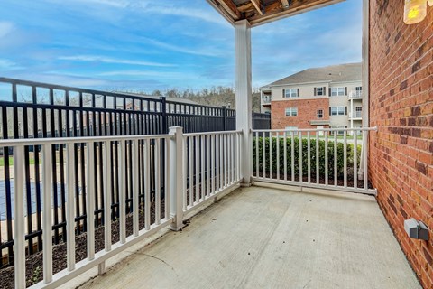the view from the balcony of an apartment building with a white railing