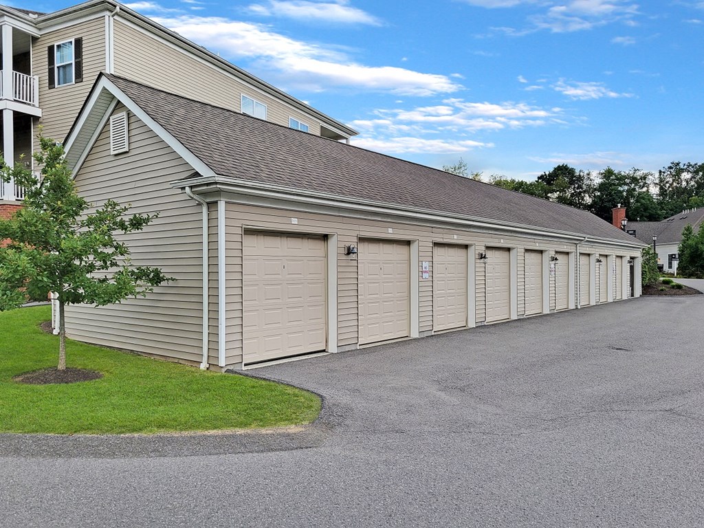 a garage with multiple doors on the side of a house