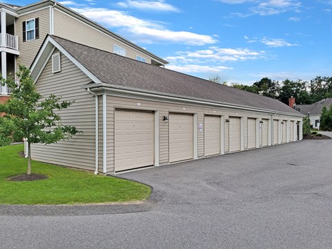 a garage with multiple doors on the side of a house