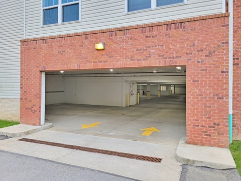 an empty parking garage in front of a brick building