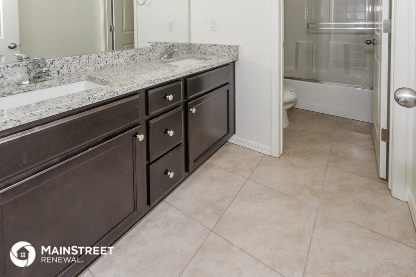 a bathroom with a sink and a toilet and a shower