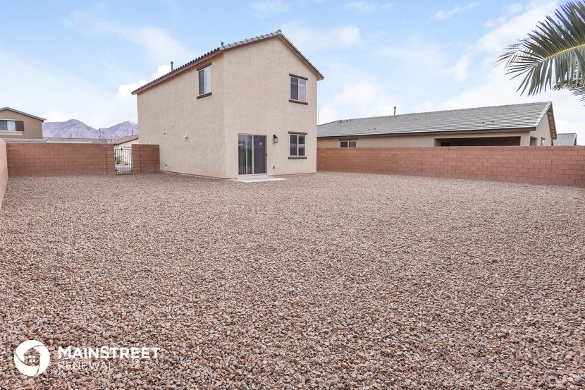 a large gravel driveway in front of a house