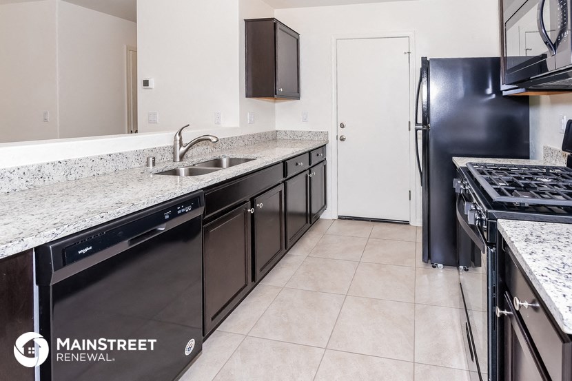 a kitchen with granite counter tops and stainless steel appliances