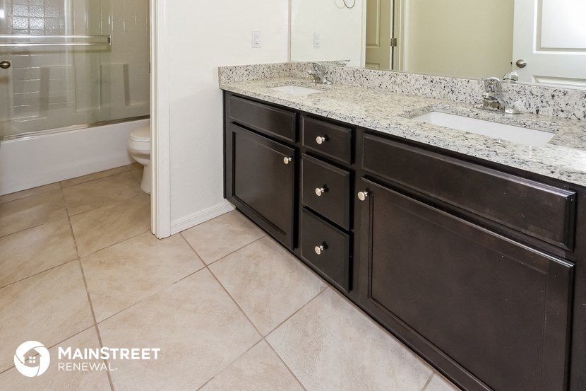 a bathroom with a sink and a mirror and a toilet