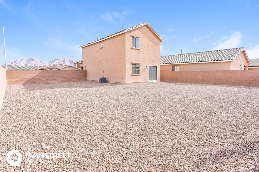 a house in the desert with a gravel driveway