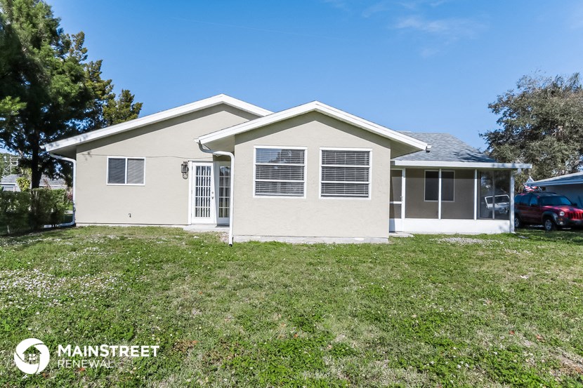 the front of a house with a yard and a garage