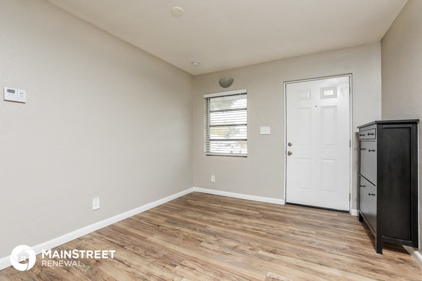 the living room is spacious and has a door to the kitchen
