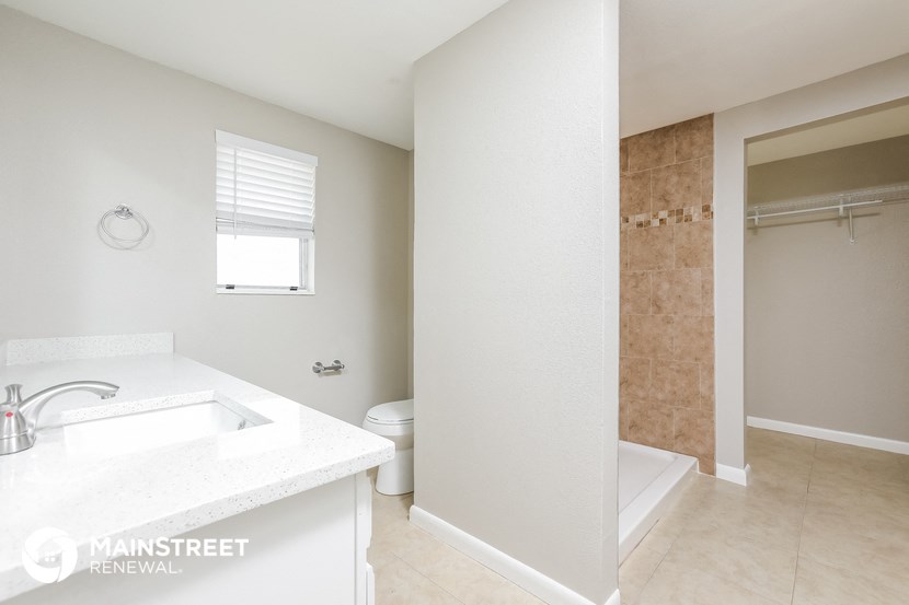 a bathroom with a sink and a shower and a toilet