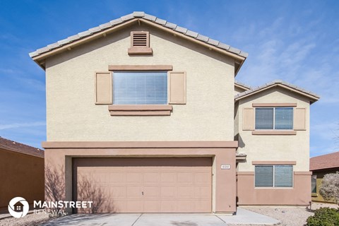 a tan house with a garage door