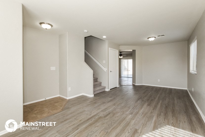 the living room and entryway of a renovated house