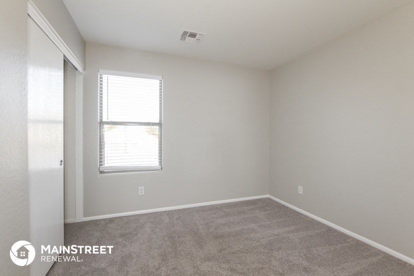 a room with a carpeted floor and a window