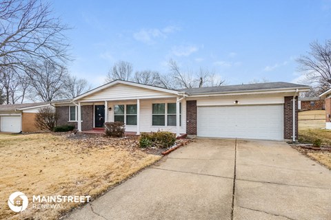 a home with a driveway and a white garage door