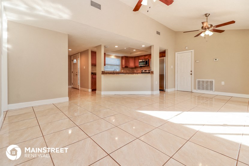 the spacious living room and kitchen are open to the dining room
